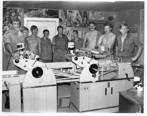 1 Australian Psychology Operations Unit (! Psyops Unit) printing room with psyops staff. Playboy centerfolds behind then on the wall.