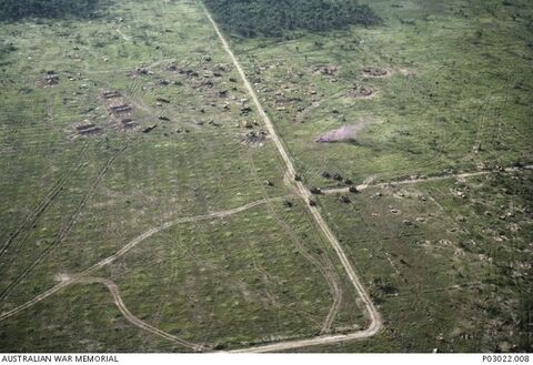 An aerial view of the central and south-eastern areas of Fire Support Base (FSB) Coral (Operation Toan Thang I) taken on the afternoon of 13 May 1968. The occupation of Coral commenced late on the afternoon of 12 May 1968. During the darkness of early morning 13 May 1968, when the FSB was only partly established, a North Vietnamese Army (NVA) unit attacked from the north-east. The three units subject of direct attack are to the right of the track running slightly diagonally from the north to sou